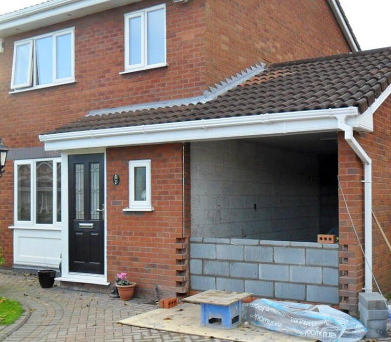 Professional garage conversion team working during construction